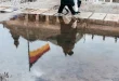 Poussette compacte avec nacelle et panier sur un trottoir urbain en plein jour