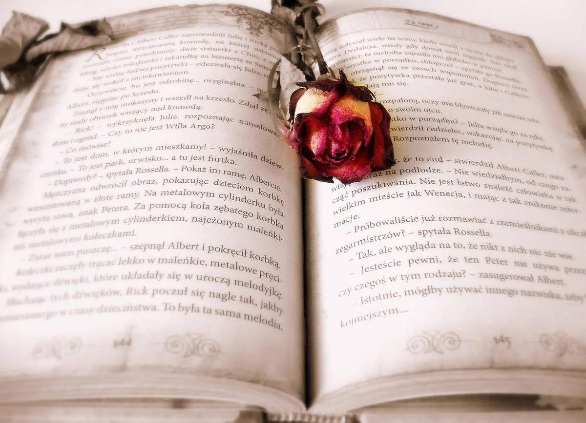 Parent lisant un livre cartonné à un tout‑petit sur un canapé lumineux